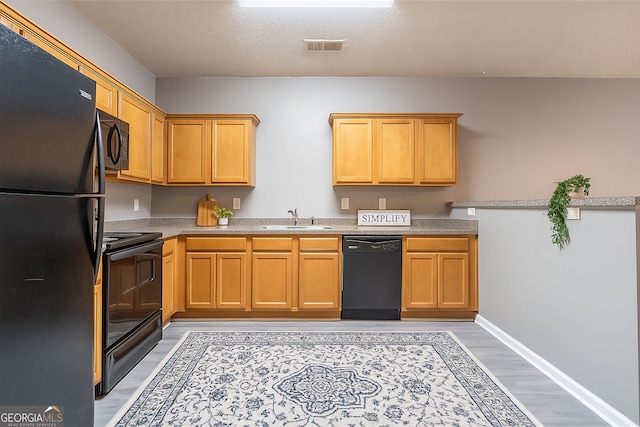 7432 Battlecreek Ln, Jonesboro, GA 30236 - kitchen with black appliances, light countertops, and light wood finished floors