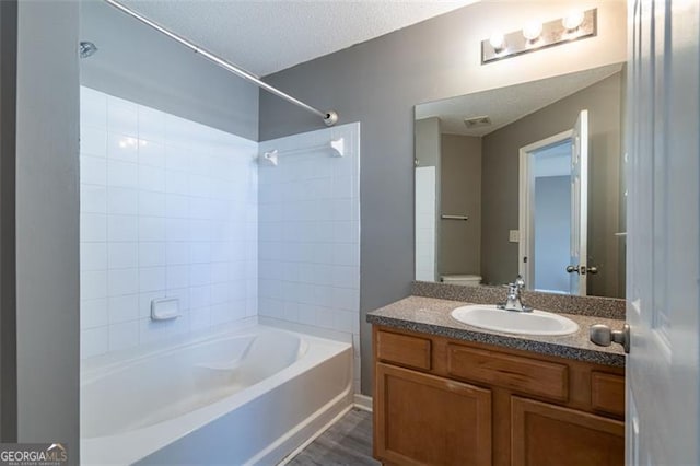 7432 Battlecreek Ln, Jonesboro, GA 30236 - full bathroom featuring washtub / shower combination, vanity, and a textured ceiling