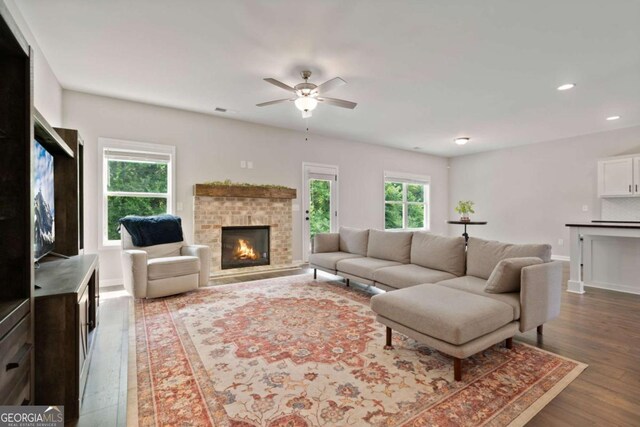 125 Kingston Cir, Carrollton, GA 30117 - living room with a fireplace, dark wood-style flooring, a ceiling fan, recessed lighting, and baseboards
