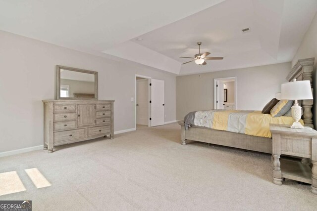 125 Kingston Cir, Carrollton, GA 30117 - bedroom featuring light carpet, a raised ceiling, baseboards, a ceiling fan, and ensuite bathroom