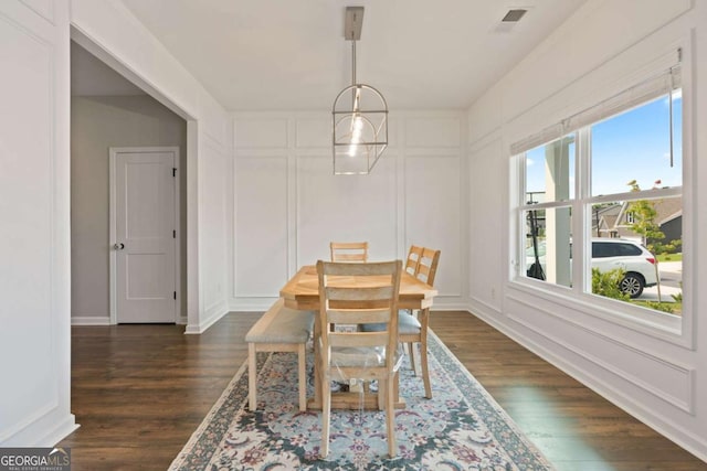 125 Kingston Cir, Carrollton, GA 30117 - dining area featuring dark wood finished floors, a decorative wall, and baseboards