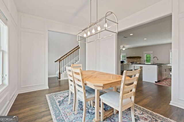 125 Kingston Cir, Carrollton, GA 30117 - dining space featuring dark wood finished floors, stairway, a decorative wall, and recessed lighting