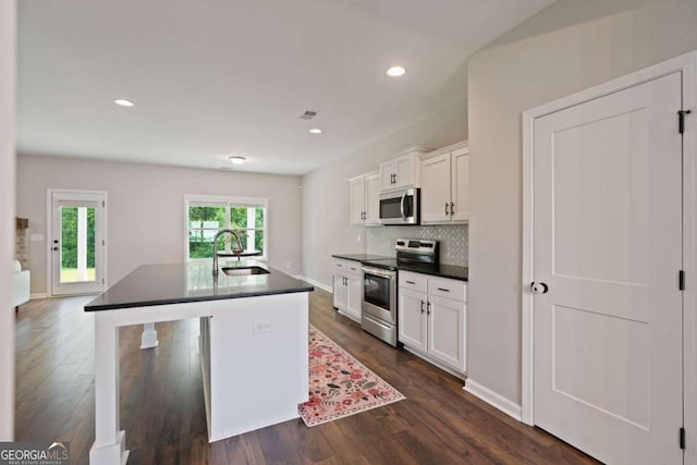 125 Kingston Cir, Carrollton, GA 30117 - kitchen featuring stainless steel appliances, a sink, dark countertops, white cabinets, and recessed lighting