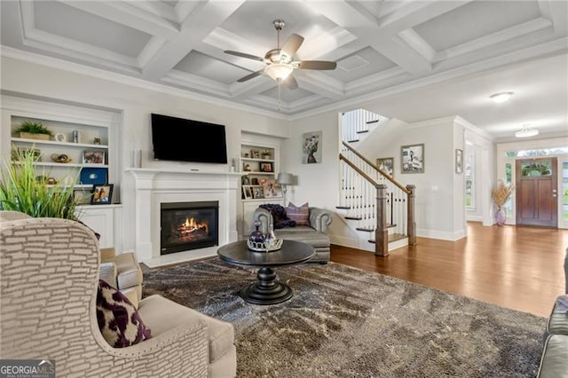 10 Nesbit Reserve Ct, Atlanta, GA 30350 - living area with wood finished floors, ceiling fan, stairs, a glass covered fireplace, and built in shelves