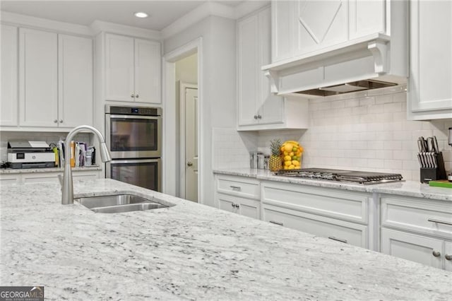 10 Nesbit Reserve Ct, Atlanta, GA 30350 - kitchen featuring stainless steel appliances, white cabinetry, recessed lighting, tasteful backsplash, and light stone countertops