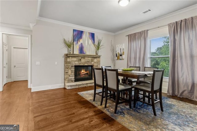 10 Nesbit Reserve Ct, Atlanta, GA 30350 - dining room featuring ornamental molding, a stone fireplace, and wood finished floors