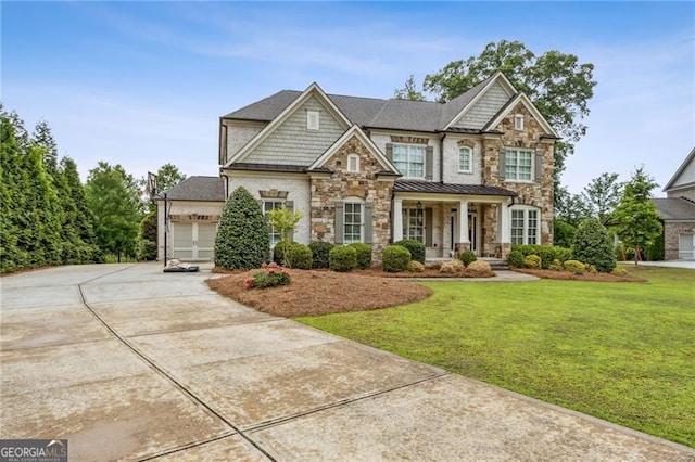10 Nesbit Reserve Ct, Atlanta, GA 30350 - craftsman-style home featuring stone siding, driveway, covered porch, and a front lawn