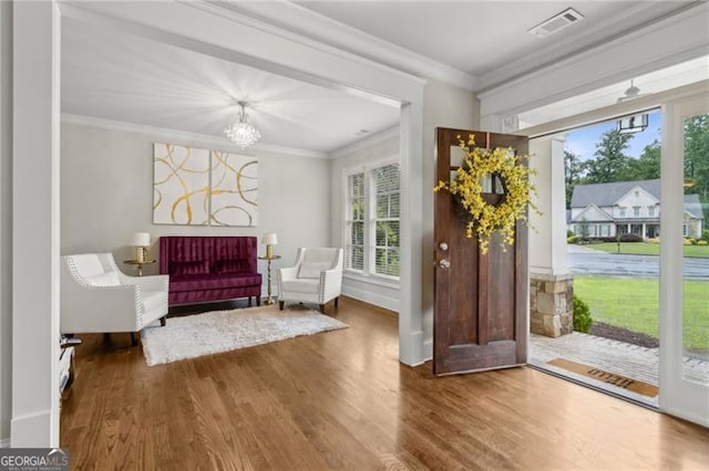 10 Nesbit Reserve Ct, Atlanta, GA 30350 - entryway featuring plenty of natural light, wood finished floors, ornamental molding, and a chandelier
