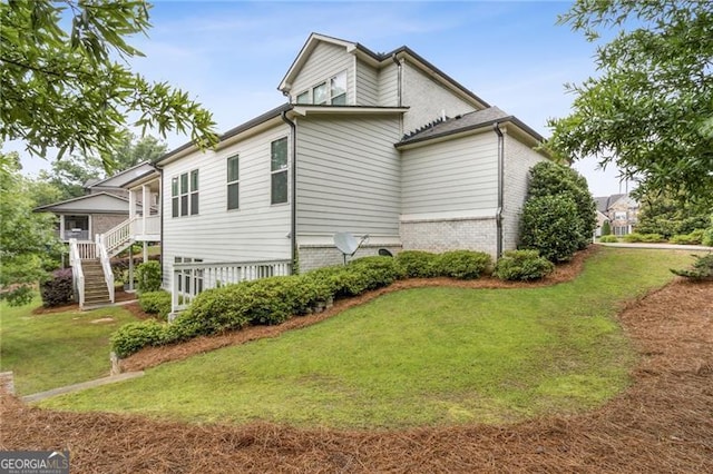 10 Nesbit Reserve Ct, Atlanta, GA 30350 - view of home's exterior with a yard, stairway, and brick siding