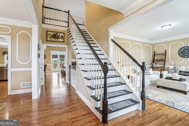 3480 Indian Shoals Rd, Dacula, GA 30019 - stairway with wood finished floors, ornamental molding, and baseboards
