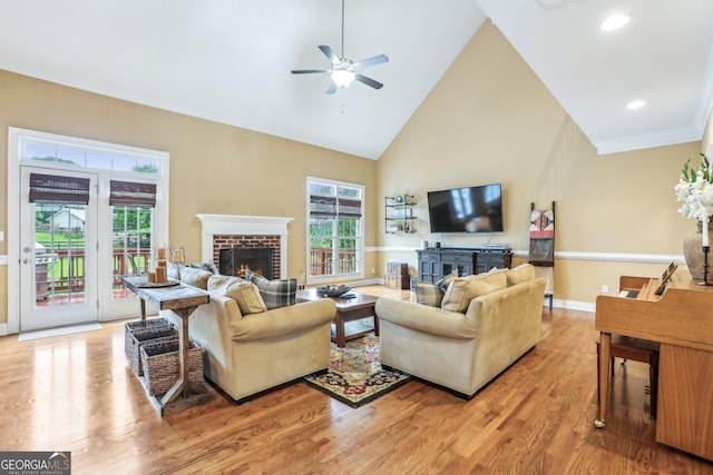 3480 Indian Shoals Rd, Dacula, GA 30019 - living room featuring a fireplace, ceiling fan, light wood-style flooring, high vaulted ceiling, and recessed lighting