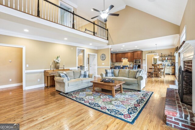 3480 Indian Shoals Rd, Dacula, GA 30019 - living area with high vaulted ceiling, ceiling fan, light wood finished floors, recessed lighting, and crown molding