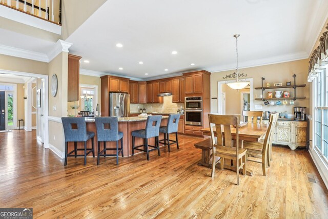 3480 Indian Shoals Rd, Dacula, GA 30019 - dining area with crown molding, light wood-style floors, recessed lighting, and baseboards