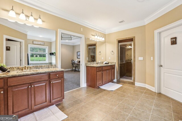 3480 Indian Shoals Rd, Dacula, GA 30019 - full bathroom featuring two vanities, crown molding, tile patterned floors, a shower stall, and baseboards