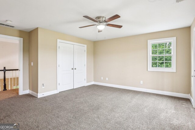 3480 Indian Shoals Rd, Dacula, GA 30019 - unfurnished bedroom featuring carpet, baseboards, a closet, and ceiling fan