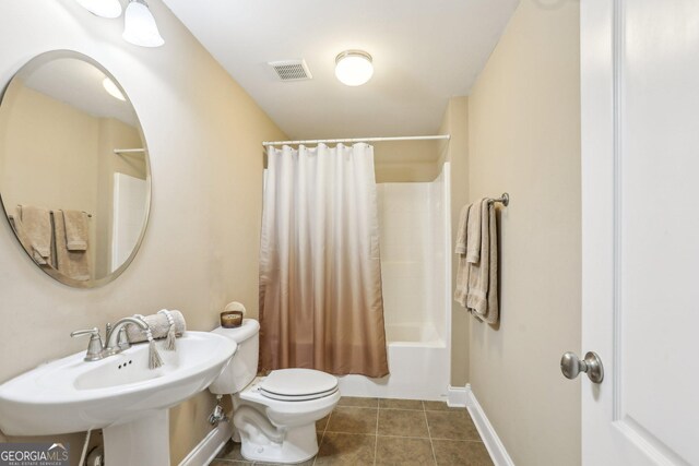 3480 Indian Shoals Rd, Dacula, GA 30019 - bathroom with tile patterned flooring, toilet, shower / bathtub combination with curtain, a sink, and baseboards