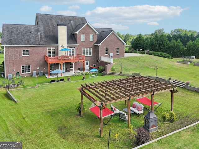 3480 Indian Shoals Rd, Dacula, GA 30019 - back of property with a fire pit, a deck, brick siding, a chimney, and a yard