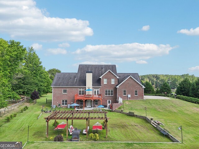 3480 Indian Shoals Rd, Dacula, GA 30019 - back of property with a deck, brick siding, and a lawn