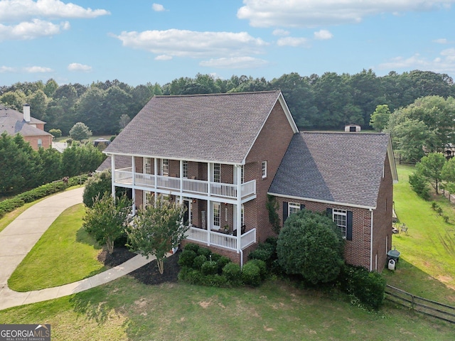 3480 Indian Shoals Rd, Dacula, GA 30019 - view of front of home featuring a balcony, brick siding, a porch, and a shingled roof