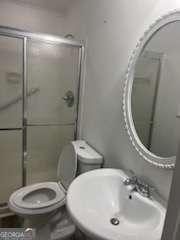 3785 Somerset Dr SW, Marietta, GA 30064 - bathroom with a sink, toilet, and a stall shower