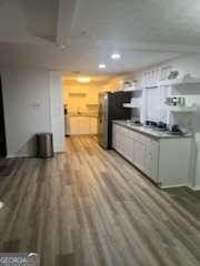 3785 Somerset Dr SW, Marietta, GA 30064 - kitchen with light wood-style flooring, recessed lighting, and fridge