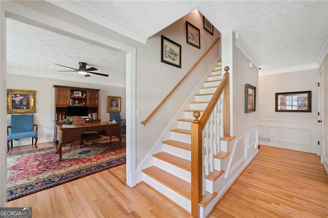 226 Nacoochee Dr, Woodstock, GA 30188 - stairs featuring wood finished floors, crown molding, a textured ceiling, and ceiling fan