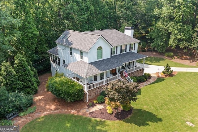 226 Nacoochee Dr, Woodstock, GA 30188 - view of front of property featuring covered porch, a chimney, a shingled roof, and a front yard