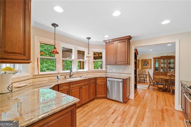 226 Nacoochee Dr, Woodstock, GA 30188 - kitchen featuring dishwasher, brown cabinetry, light stone countertops, pendant lighting, and crown molding