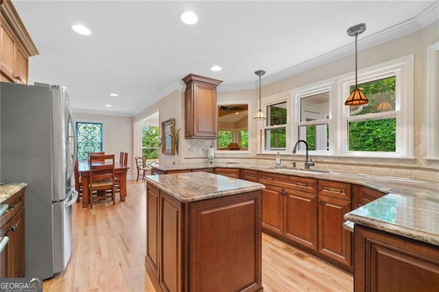 226 Nacoochee Dr, Woodstock, GA 30188 - kitchen with freestanding refrigerator, crown molding, light stone countertops, tasteful backsplash, and light wood-type flooring
