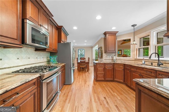 226 Nacoochee Dr, Woodstock, GA 30188 - kitchen featuring stainless steel appliances, ornamental molding, light wood-style floors, brown cabinets, and decorative backsplash