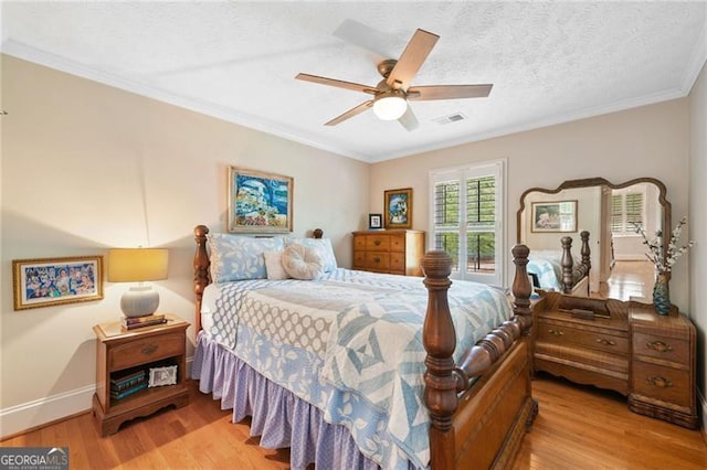 226 Nacoochee Dr, Woodstock, GA 30188 - bedroom featuring light wood-style floors, ornamental molding, a textured ceiling, and ceiling fan