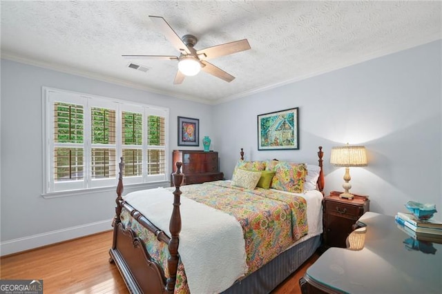 226 Nacoochee Dr, Woodstock, GA 30188 - bedroom featuring wood finished floors, ornamental molding, a textured ceiling, and a ceiling fan