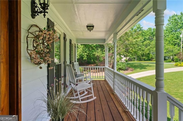 226 Nacoochee Dr, Woodstock, GA 30188 - wooden porch featuring a yard