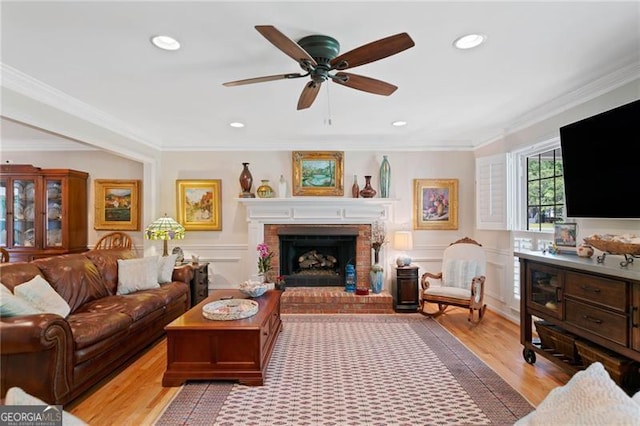 226 Nacoochee Dr, Woodstock, GA 30188 - living area featuring light wood-style flooring, ornamental molding, recessed lighting, a fireplace, and ceiling fan