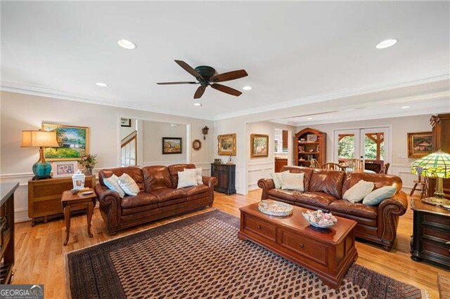 226 Nacoochee Dr, Woodstock, GA 30188 - living room with ornamental molding, a ceiling fan, light wood-type flooring, a decorative wall, and french doors