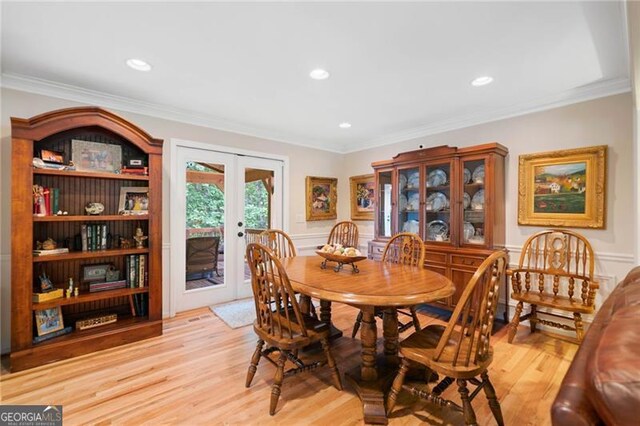 226 Nacoochee Dr, Woodstock, GA 30188 - dining space featuring french doors, light wood-style flooring, ornamental molding, a wainscoted wall, and a decorative wall