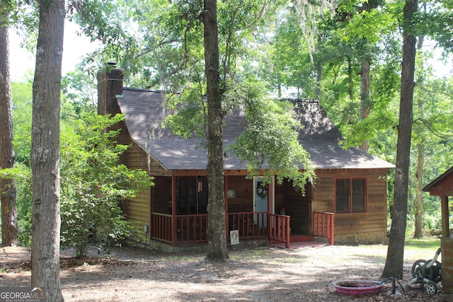 2879 Mcmillan Jernigan, Enigma, GA 31749 - view of front facade featuring a porch, roof with shingles, and a chimney