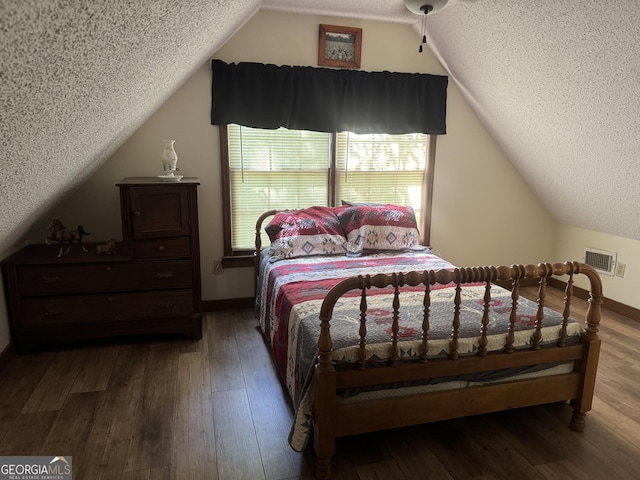 2879 Mcmillan Jernigan, Enigma, GA 31749 - bedroom featuring a textured ceiling, vaulted ceiling, and wood finished floors