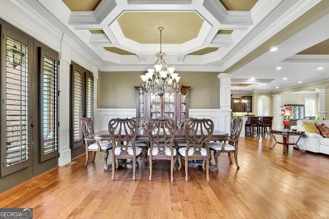 2450 Weber Heights Way, Buford, GA 30519 - dining room with crown molding, a chandelier, wood finished floors, a decorative wall, and coffered ceiling