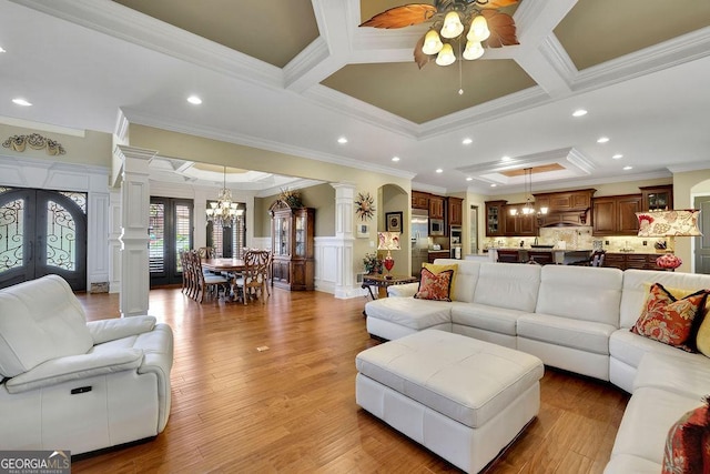 2450 Weber Heights Way, Buford, GA 30519 - living area with a chandelier, ornate columns, crown molding, coffered ceiling, and a ceiling fan