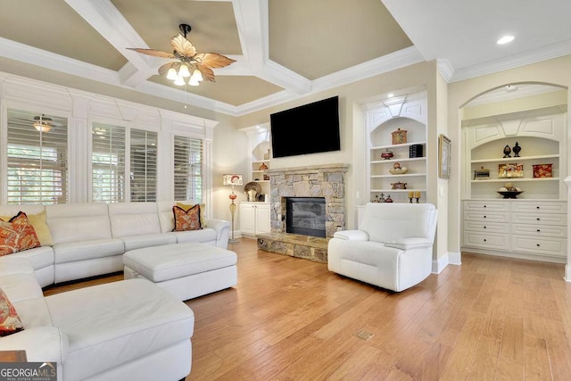 2450 Weber Heights Way, Buford, GA 30519 - living room with crown molding, ceiling fan, a fireplace, light wood-style flooring, and built in features