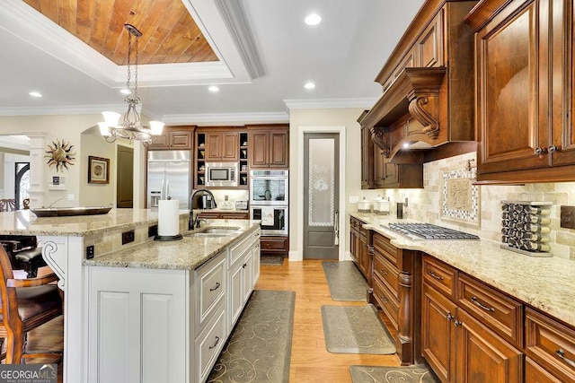 2450 Weber Heights Way, Buford, GA 30519 - kitchen with built in appliances, a breakfast bar area, a tray ceiling, open shelves, and light stone countertops