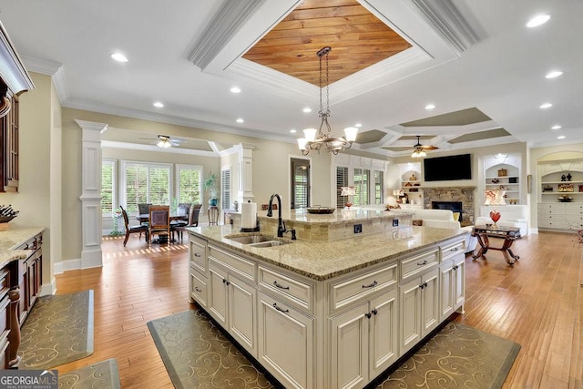 2450 Weber Heights Way, Buford, GA 30519 - kitchen with ceiling fan, a sink, decorative columns, crown molding, and a fireplace