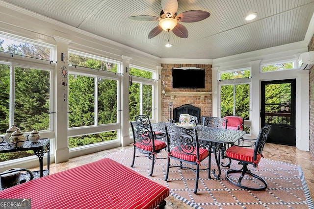 2450 Weber Heights Way, Buford, GA 30519 - sunroom featuring outdoor dining space, ceiling fan, a wall mounted AC, a fireplace, and crown molding