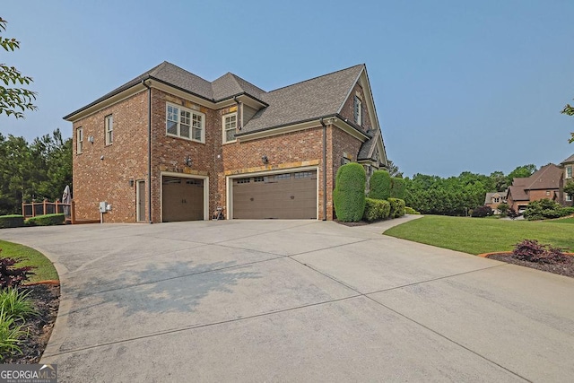 2450 Weber Heights Way, Buford, GA 30519 - view of side of property featuring a garage, driveway, brick siding, and a yard