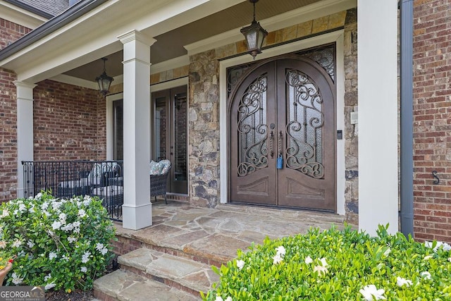 2450 Weber Heights Way, Buford, GA 30519 - view of exterior entry with a porch, french doors, and brick siding
