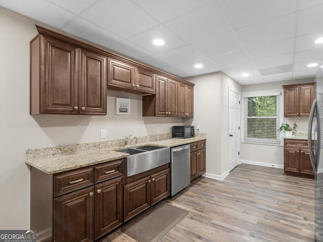 507 N Green Cir, Mcdonough, GA 30252 - kitchen with stainless steel appliances, light wood-style flooring, light stone countertops, recessed lighting, and dark brown cabinetry