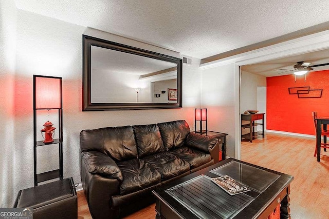 250 Little St Unit C106, Athens, GA 30605 - living area featuring wood finished floors, ceiling fan, a textured ceiling, and baseboards