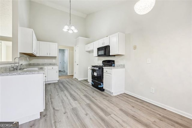 245 London Ln, Hiram, GA 30141 - kitchen with black appliances, a chandelier, high vaulted ceiling, white cabinetry, and light countertops