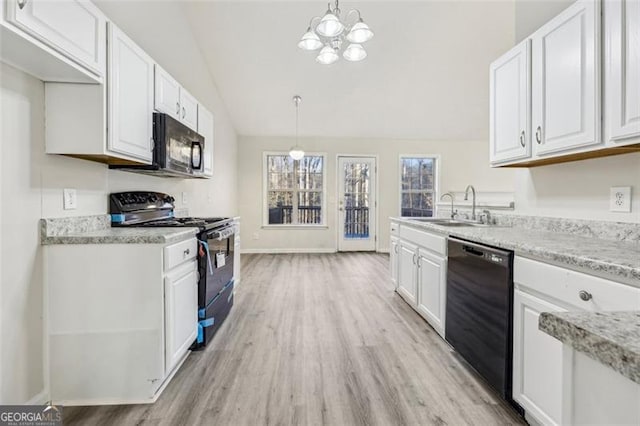245 London Ln, Hiram, GA 30141 - kitchen with black appliances, light wood-style flooring, white cabinets, and lofted ceiling